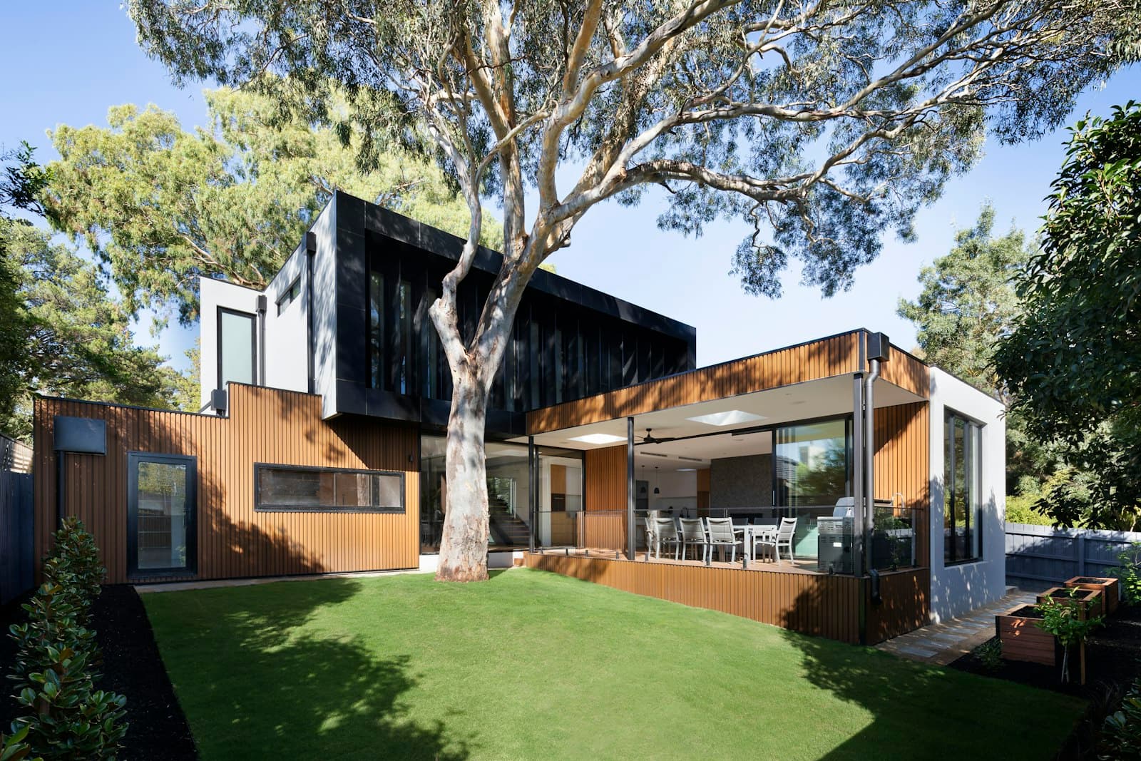 A timber-clad rear extension opening onto a garden